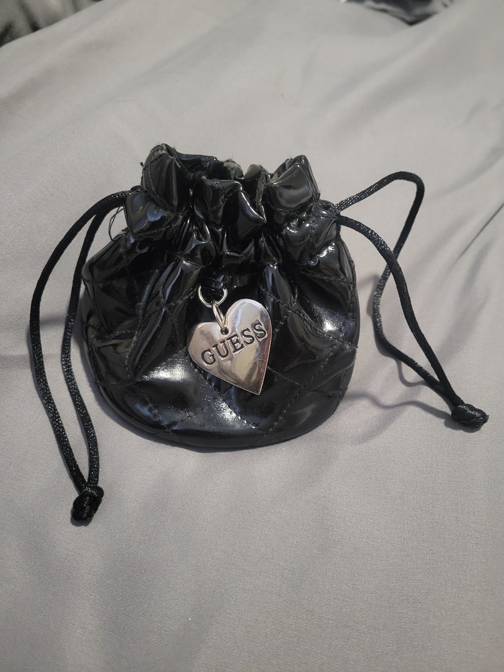 GUESS Black Quilted Patent Drawstring Pouch with Heart Charm